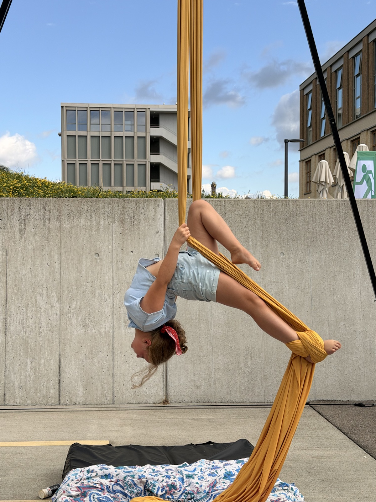 Mathilde hanging upside down on aerial silks