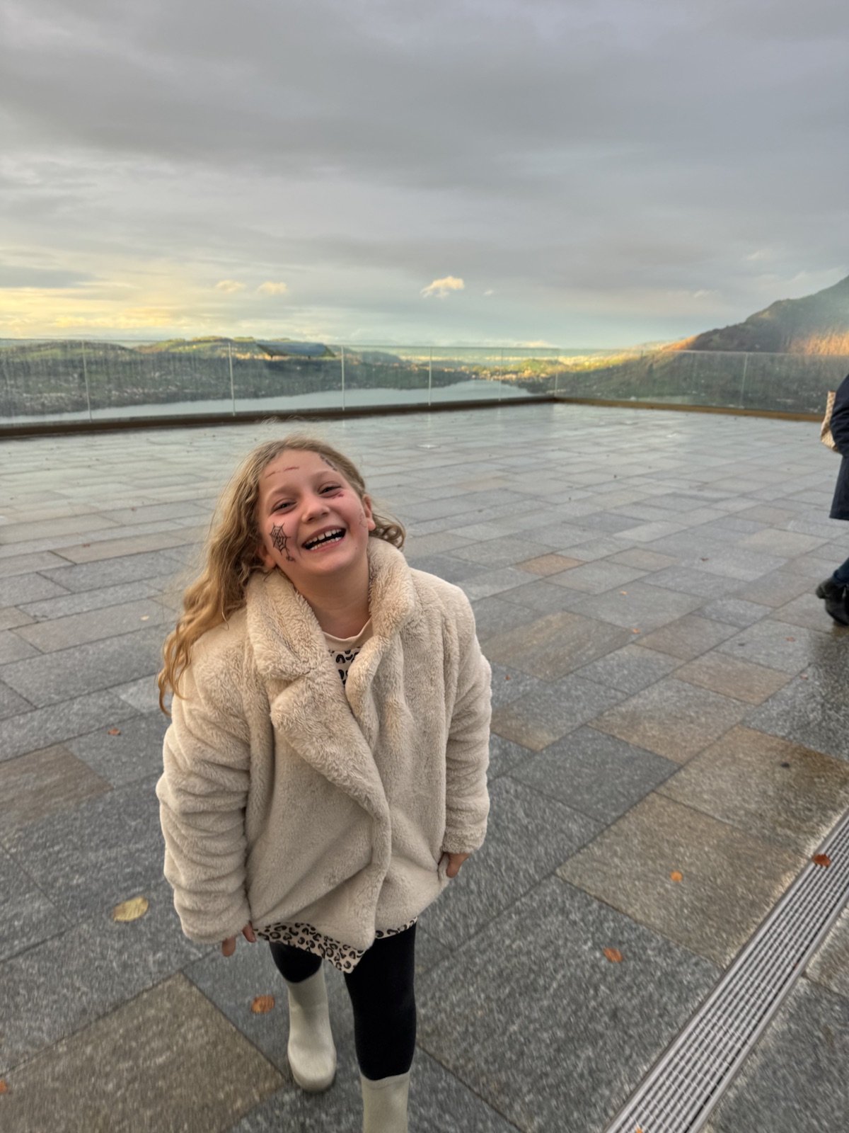 Mathilde laughing on a lake-view terrace