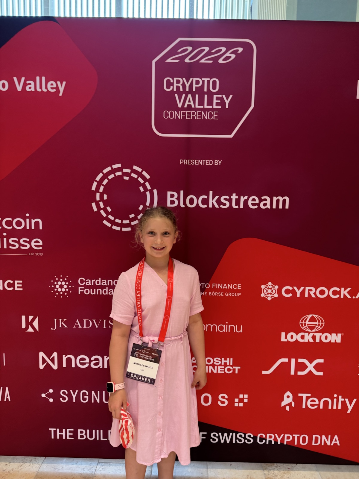 Mathilde at a conference wearing a speaker badge